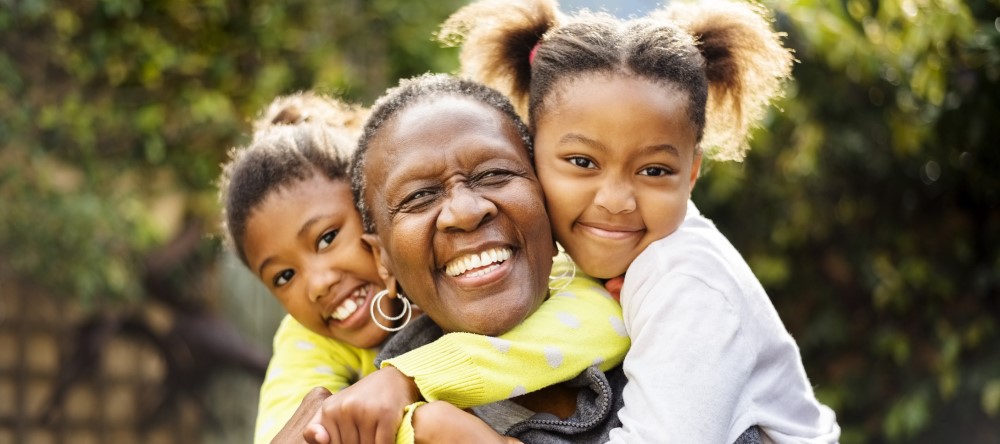 Medicare aged woman playing with grandkids